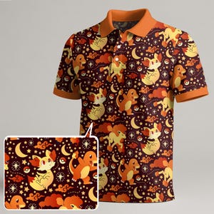 May include: A short-sleeved polo shirt with a repeating pattern of cartoon characters, moons, stars, and clouds in shades of orange and yellow on a dark maroon background. The collar and sleeve cuffs are orange.