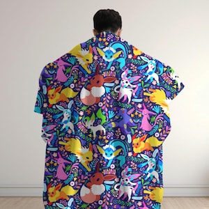 May include: A dark blue blanket featuring a repeating pattern of various colorful Eevee evolution characters interspersed with vibrant floral and leaf motifs in shades of pink, yellow, light blue, and green across the entire fabric surface.