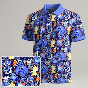 May include: A blue polo shirt with a vibrant pattern featuring cartoon characters in shades of blue, yellow, orange, and white. The shirt has a light blue collar and short sleeves with blue trim. The design is repeated on a smaller, rectangular inset.