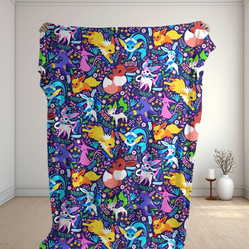 May include: A rectangular throw blanket featuring a repeating pattern of various colorful Eevee evolution characters set against a dark purple background filled with vibrant floral and leaf motifs in shades of pink, blue, and green.