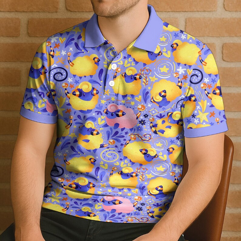 May include: A short-sleeved polo shirt with a whimsical pattern of yellow sheep with blue and black accents on a light purple background. The shirt has a light blue collar and sleeve cuffs.