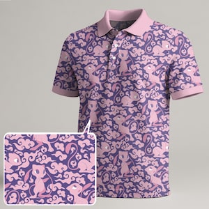 May include: A purple polo shirt with a pink collar and sleeves. The shirt features a repeating pattern of pink cartoon characters and cloud designs. The shirt has a three-button placket.