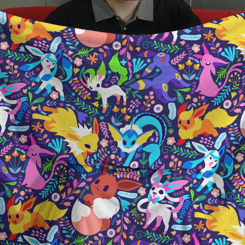 May include: A soft fleece blanket featuring a dark purple background with a repeating pattern of various colorful cartoon creatures and stylized floral elements in shades of yellow, pink, blue, green, and white across the entire fabric surface.