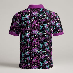 May include: Black polo shirt with a purple collar and sleeve trim. The shirt features a repeating pattern of purple and teal cartoon characters and pokeballs on a black background.