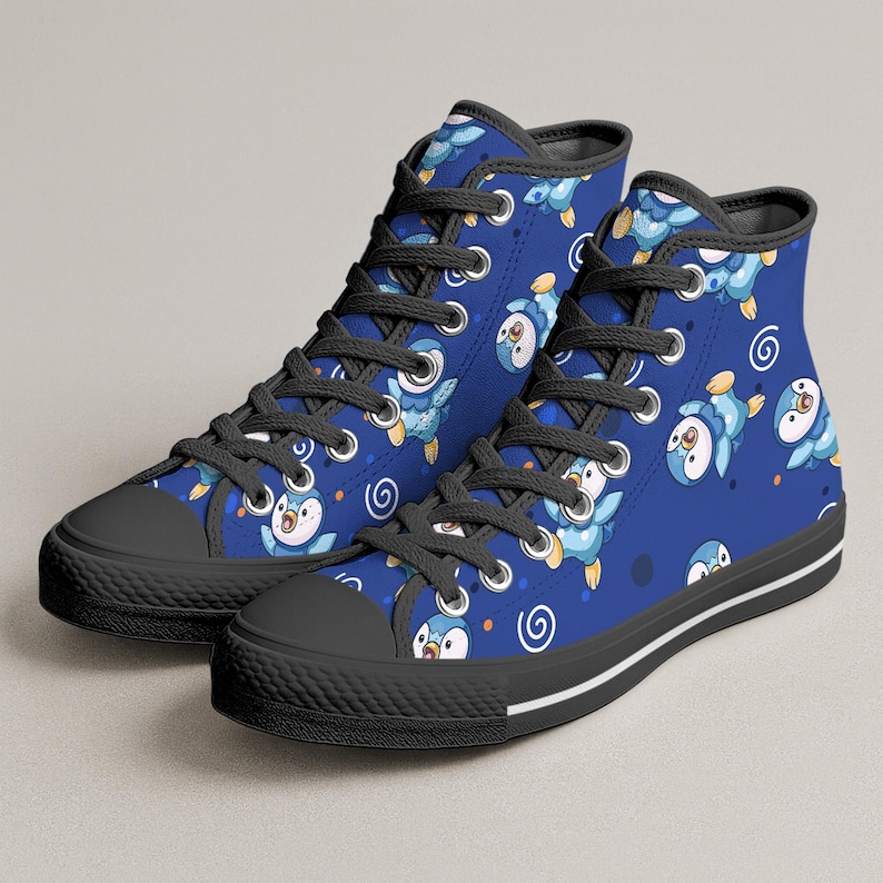 May include: Blue high-top sneakers with a repeating pattern of cartoon penguins. The sneakers have black laces, a black toe cap, and a black sole with a white stripe. The penguin design features blue, white, and orange colors.