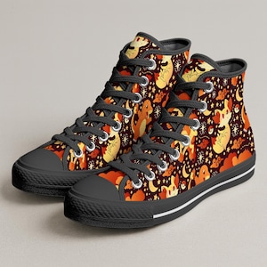 May include: Pair of high-top sneakers with a repeating pattern of cartoon characters, moons, and stars in shades of orange and yellow on a dark burgundy background. The sneakers have black laces, toe caps, and soles, with a white stripe along the sole.
