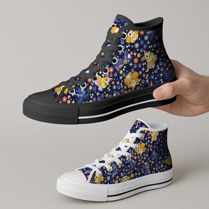 May include: High-top canvas sneakers with a navy blue background and a repeating pattern of cartoon corgis, bones, and flowers in yellow, orange, and blue. The shoes have black soles and laces.