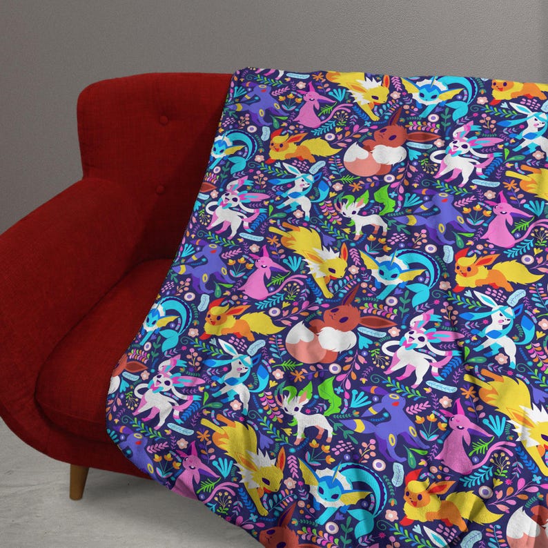 May include: A soft throw blanket featuring a dark purple background with a repeating pattern of various colorful cartoon creatures, including yellow, blue, pink, and brown characters interspersed with green leaves and small flowers.