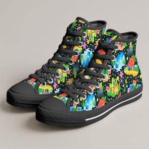 May include: Pair of high-top canvas sneakers with a whimsical, colorful pattern. The design features mushrooms, flowers, and other fantasy elements on a black background. The shoes have black laces, soles, and toe caps.