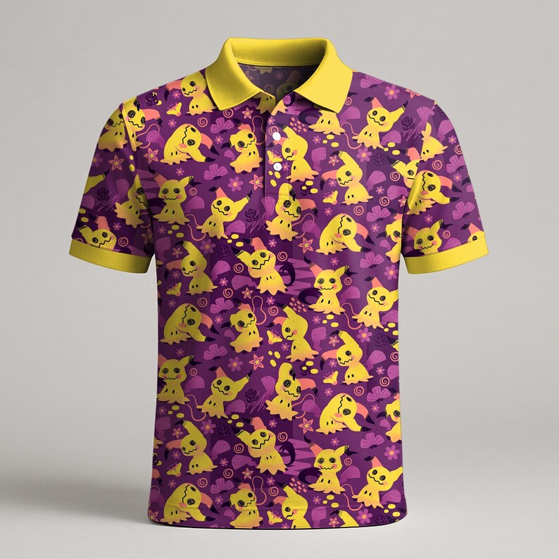 May include: Purple polo shirt featuring a repeating pattern of yellow cartoon characters and floral accents. The collar and sleeve cuffs are yellow. The shirt has a three-button placket.
