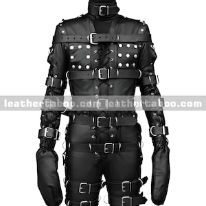 May include: Black leather restraint suit with multiple straps, buckles, and studded accents. The suit features a high collar, long sleeves with attached mittens, and a series of straps across the chest, arms, and legs. The suit is designed for restraint purposes.