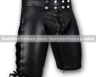 May include: Black leather shorts with lace-up detailing on the sides and front. The shorts feature a zipper closure on one side and silver-tone button accents on the waistband. The text "leathertaboo.com" is visible.