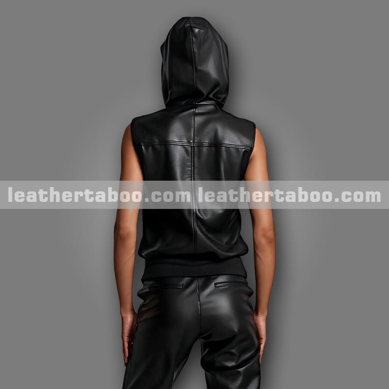 May include: A black leather hooded vest and matching trousers. The sleeveless vest has a hood and a fitted waist. The trousers are also black leather. The website leathertaboo.com is printed across the image.