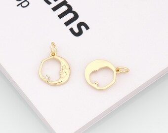May include: Two gold-colored moon pendants. One pendant features a crescent moon with a face and a small, clear gemstone. The other pendant is a simple outline of a crescent moon. Both have small loops for attaching to a chain.