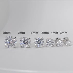 May include: A selection of six diamond stud earrings, varying in size from 3mm to 8mm. The earrings are round-cut with a sparkling appearance, set in a silver or white metal. Sizes are indicated above each earring.