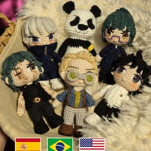 May include: A collection of handmade crochet dolls, each with unique features and outfits. The dolls include a panda, characters with green, white, and black hair, and others wearing glasses. The dolls are arranged on a fluffy, cream-colored surface. The text "@illumaamigurumi" is visible.