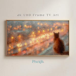 以下が含まれることがあります： 4K UHDフレームTV用の額入りデジタルアートプリント。このアートワークは、暖かいオレンジ色と黄色の光がぼやけた都市景観を見ている猫のシルエットを特徴としています。「4K UHD Frame TV Art」というテキストが上部にあります。