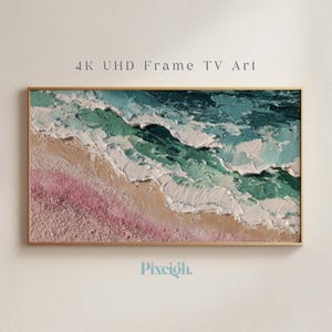 May include: A rectangular framed artwork showing a textured ocean scene. The waves are teal and white, meeting a pink and tan beach. The text "4K UHD Frame TV Art" is at the top, and the logo "Pixeigh" is at the bottom.