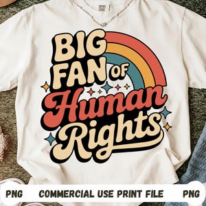 May include: Cream-colored t-shirt with the text "BIG FAN of Human Rights" in a retro font, featuring a rainbow and star accents. The shirt is a commercial use print file.