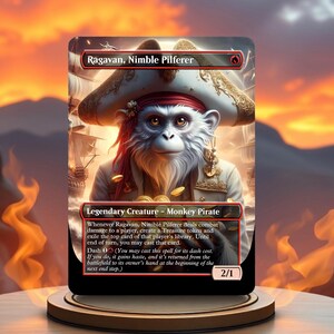May include: A Magic: The Gathering card featuring Ragavan, Nimble Pilferer, a legendary monkey pirate creature with a red bandana and a pirate hat. The card has a black background with red and gold accents. The text on the card reads "Ragavan, Nimble Pilferer" and "Legendary Creature - Monkey Pirate".