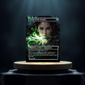 May include: A green and gold Magic: The Gathering card with a woman with green eyes and a sword. The card text reads "Sword of the Animist".  Legendary Artifact - Equipment. Equipped creature gets +1/+1. Whenever equipped creature attacks, you may search your library for a basic land card, put it onto the battlefield tapped, then shuffle. Equip 2."