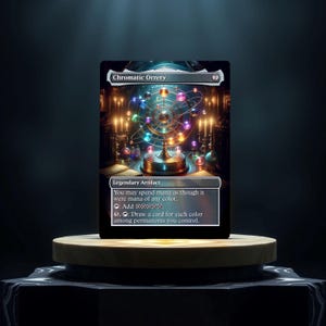 May include: A fantasy card game card with a gold and blue design. The card is called "Chromatic Orrery" and is a legendary artifact. The card text reads: "You may spend mana as though it were mana of any color. : Add . : Draw a card for each color among permanents you control."