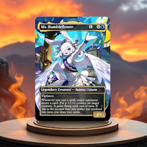May include: A Magic: The Gathering card featuring "Ms. Bumbleflower," a white rabbit-like character with wings, wearing a sash that says "Bumbleflower." The card has a colorful background and text describing its abilities. The card is on a wooden stand.