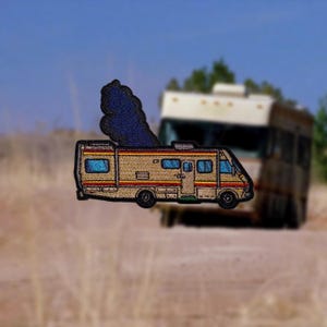 May include: A brown and yellow camper van with a blue smoke plume coming from the back. The van has a white stripe and red accents. The van is a popular icon from the TV show Breaking Bad.