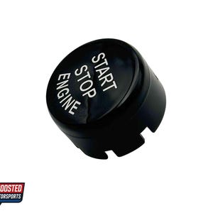 May include: A black engine start/stop button with white lettering. The text reads "START STOP ENGINE". The button has a rounded top and a notched base. The Boosted Motorsports logo is in the lower left corner.