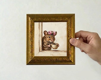 May include: A framed painting depicts a mouse wearing pink curlers, holding a cup of coffee, and looking out a window. The painting is in a gold ornate frame. The artwork has a whimsical and charming aesthetic.