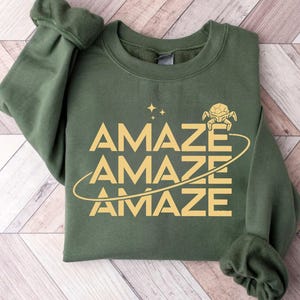 Op de afbeelding: Een witte keramische mok met een zwart handvat en de tekst "But First, Coffee" in een zwarte, vette letter. De mok staat op een wit oppervlak. De mok is ongeveer 10 cm hoog.