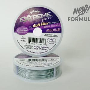 May include: Two spools of Silver Extreme Flex metallic beading wire by Soft Flex Company. The top spool label reads New! Formula, 20 lbs. test strength, 49 strands, .019 in. diameter, and 25 ft. length. The bottom spool shows the coiled silver wire.