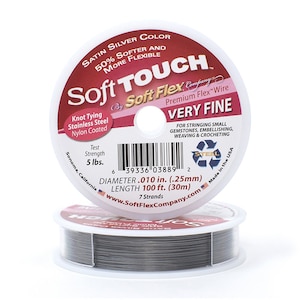May include: A spool of silver Soft Touch Premium Flex Wire, very fine, 7 strands, 0.010 inches in diameter, 100 feet long, 5 lbs test strength, made in the USA.  The label says "Knot Tying Stainless Steel Nylon Coated" and "For stringing small gemstones, embellishing, weaving & crocheting".