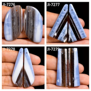 May include: Four pairs of polished blue and brown banded agate pendants labeled JI-7276, JI-7277, JI-7278, and JI-7279. Each pair features distinct geometric shapes including rounded, triangular, and rectangular forms with drilled holes for suspension.