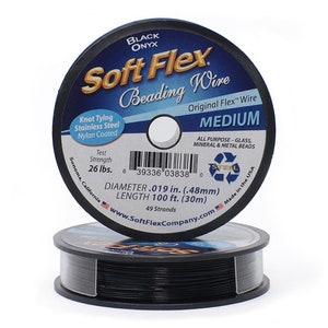 May include: Two spools of Soft Flex beading wire in black onyx. The label indicates the wire is nylon coated, stainless steel, and suitable for knot tying. The wire has a diameter of .019 in. (.48mm) and a length of 100 ft. (30m).