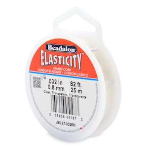 May include: A spool of clear Beadalon Elasticity elastic cord. The label reads: .032 in, 82 ft, 0.8 mm, 25 m. The label is white and red with the words "Elasticity" and "Elastic Cord".
