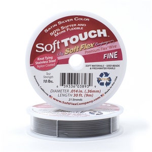 May include: A spool of silver Soft Touch Premium Flex Wire, labeled "Fine" and "Soft Materials - Seed Beads & Freshwater Pearls". The spool is 30 feet (9 meters) long and has a diameter of 0.014 inches (0.36 mm).