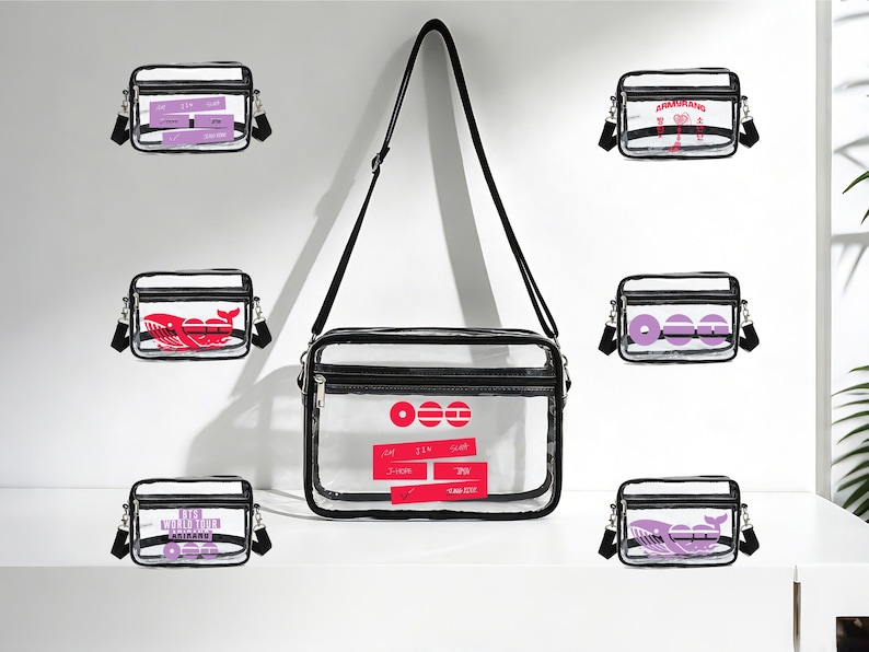 May include: Transparent crossbody bag with black trim and strap. The bag contains various designs, including a red whale, purple text, and red circles. The bag is displayed on a white surface.
