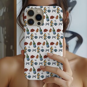 May include: White phone case with a repeating pattern of wine bottles, glasses, lemons, bows, and red cloud shapes. The case has a glossy finish and is held in front of a person's face.