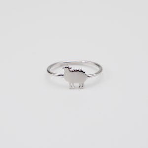 May include: A silver ring with a sheep silhouette design.