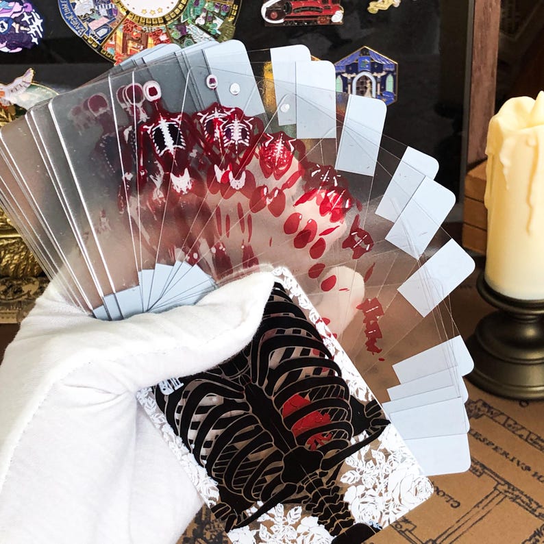 Transparent Skeleton Slice Playing Cards shown mid-flourish in a dynamic hand display, capturing the light through the clear cards while the red UV skeleton ink glows subtly, tailored for advanced cardists, street performers, and those searching for artistic cardistry props and poker accessories.
