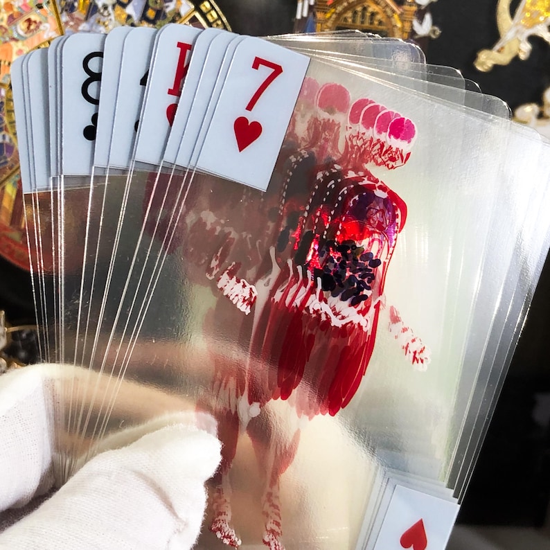 Image of Transparent Skeleton Playing Cards stacked in a neat pile next to a poker chip set and magician’s wand, conveying their use as a functional magic trick deck or science-themed poker night upgrade, combining education with entertainment and unique gifting potential.