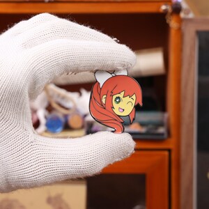 DDLC anime enamel pin set displayed on a decorative board, showcasing the glossy enamel finish and detailed character design. These pins are inspired by the popular visual novel Doki Doki Literature Club and are perfect for fans of galgames, anime aesthetics, and kawaii accessories. Whether used for Halloween cosplay, Christmas holiday gifts, or everyday ita bag fashion, these character pins offer great collectible value for Etsy buyers and anime collectors.