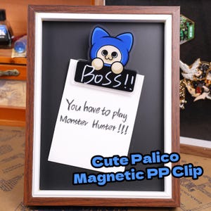 May include: A framed black chalkboard with a white paper note held by a Palico character clip. The clip has the word "Boss!!" on it. The note reads "You have to play Monster Hunter!!!" and the bottom says "Cute Palico Magnetic PP Clip".