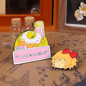 Close-up shot of kawaii enamel badges inspired by Doki Doki Literature Club characters Sayori, Natsuki, Yuri, and Monika, including famous quotes from the game. These vibrant anime enamel pins are great for cosplay looks, Halloween outfits, and Christmas stocking stuffer ideas. Perfect for display on ita bags, pinboards, or gifting to a visual novel fan. Great for anime lovers shopping for unique enamel pins, cute gamer gifts, or DDLC-themed accessories on Etsy.