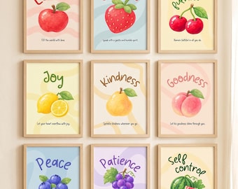 May include: A set of nine framed wall art prints titled Fruits of the Spirit. Each print features a watercolor fruit illustration with a corresponding virtue: Love with an apple, Gentleness with a strawberry, Faithfulness with cherries, Joy with a lemon, Kindness with a pear, Goodness with a peach, Peace with blueberries, Patience with grapes, and Self-control with a watermelon.