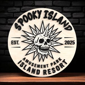 May include: A circular wooden sign with the words "Spooky Island Amusement Park Island Resort" in black. It features a skull within a starburst design, with the year 2025.