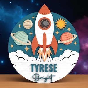 May include: A wooden, circular space-themed decoration featuring a white and orange rocket ship with flames, planets, stars, and the name "TYRESE Bright" in teal script. The background depicts a starry sky.