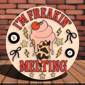 May include: A round wooden sign with the text "I'M FREAKIN' MELTING" in red. The design features a melting ice cream cone with a cherry on top, lightning bolts, stars, bows, and two 8-ball symbols.
