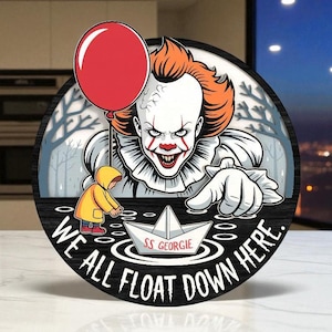May include: Circular wooden sign depicting a scary clown with a red balloon and the words "WE ALL FLOAT DOWN HERE." A child in a yellow raincoat reaches for a paper boat labelled "SS Georgie."